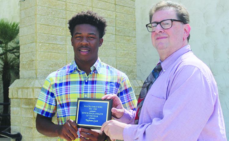 Recent Crescent City Junior-Senior High standout Naykeem Scott poses alongside sports editor Mark Blumenthal with the Daily News’ Senior Male Athlete of the Year honor. (SARAH CAVACINI / Palatka Daily News)