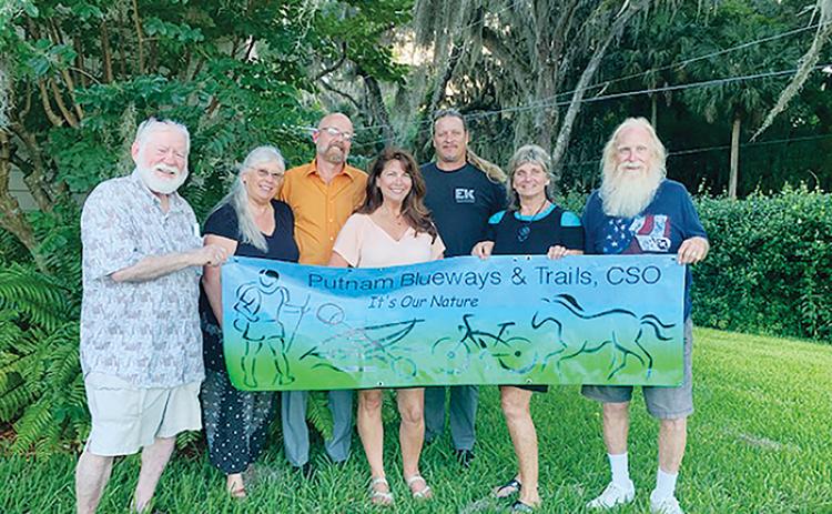 Members of Putnam Blueways & Trails Citizens Support Organization stand together while holding the club’s sign for all to see.
