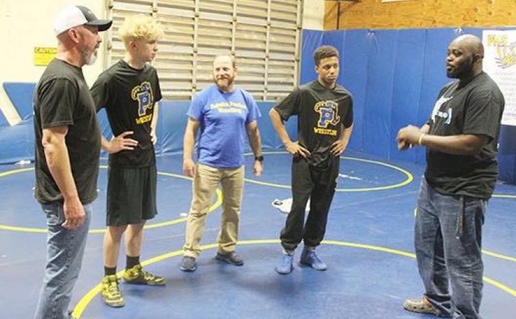Palatka assistant wrestling coach Elysha Campbell (right) chats after a practice with (from left) assistant coach Richie Lewis, wrestler Brandon Lewis, head coach Josh White and wrestler Mikade Harvey. (MARK BLUMENTHAL/Palatka Daily News)