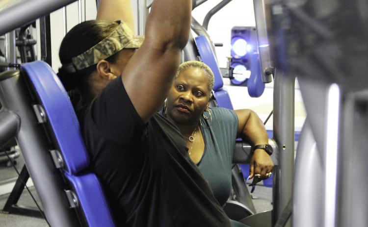 Photo by Sarah Cavacini/Palatka Daily News. Personal trainer Tracei Salome Hutcherson works with her client, Patricia Spell, as she completes one exercise Friday afternoon at Hutcherson's Palatka facility. 