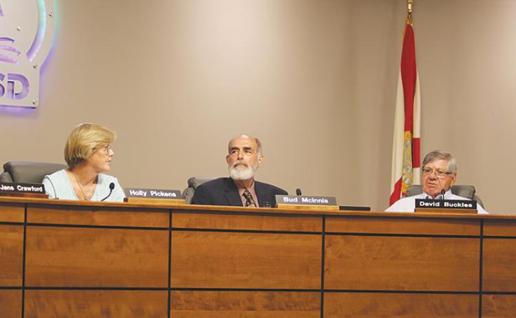Putnam County School Board members listen to opinions Tuesday during a conversation about moving board meetings back an hour.