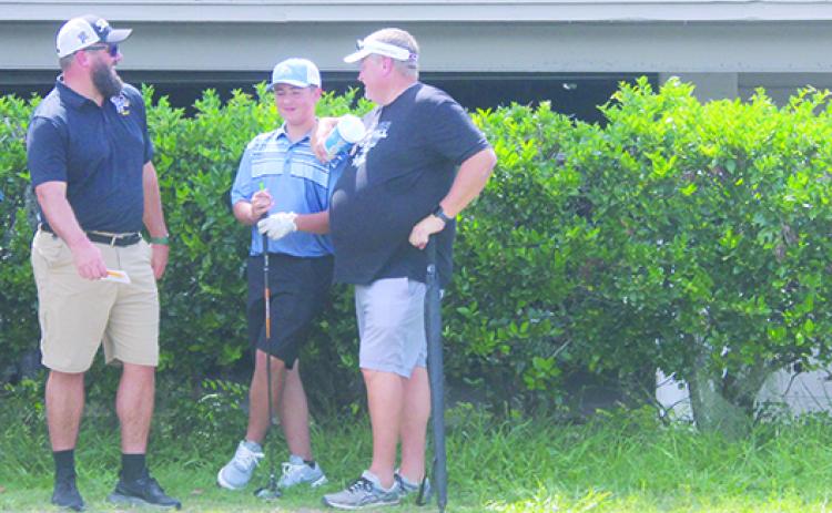 Palatka coach Jeff Malandrucco (left) and Peniel Baptist Academy coach Jeff Hutchins chat with new Peniel Baptist golfer Caleb Preston during the team’s first-ever match at Palatka Municipal Golf Club on Aug. 23. (MARK BLUMENTHAL / Palatka Daily News)