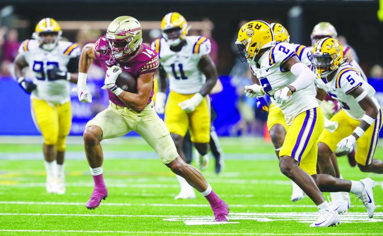 Florida State’s Johnny Wilson looks to pick up yards after making a catch against LSU on Sept. 4. (GREG OYSTER / Special to the Daily News)