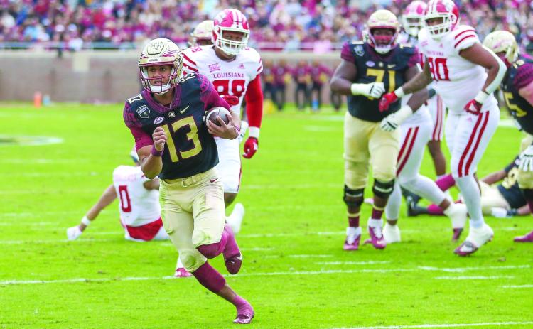 Florida State quarterback Jordan Travis scores on a 13-yard run during the first half against Louisiana last Saturday. (GREG OYSTER / Special to the Daily News)