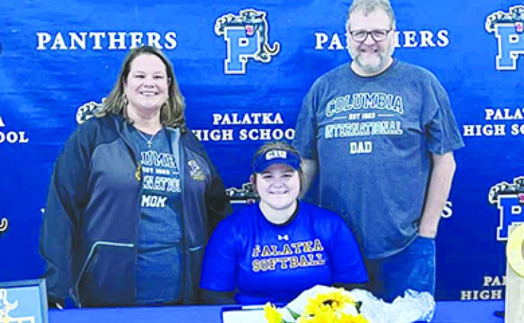 Palatka Junior-Senior High softball player MaryBeth Wallace smiles before signing her letter of intent to play next year at Columbia International University. Enjoying the moment with her are her mother, Heather, and father, James. (Photo courtesy of Palatka High Softball Facebook page)