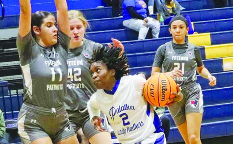 Palatka’s Zy’ria Jones tries to dribble around Orlando Freedom’s Mona El Dali (11) and Rachel Daily during Wednesday’s opening-round match won by Palatka, 44-34. (RITA FULLERTON / Special to the Daily News)