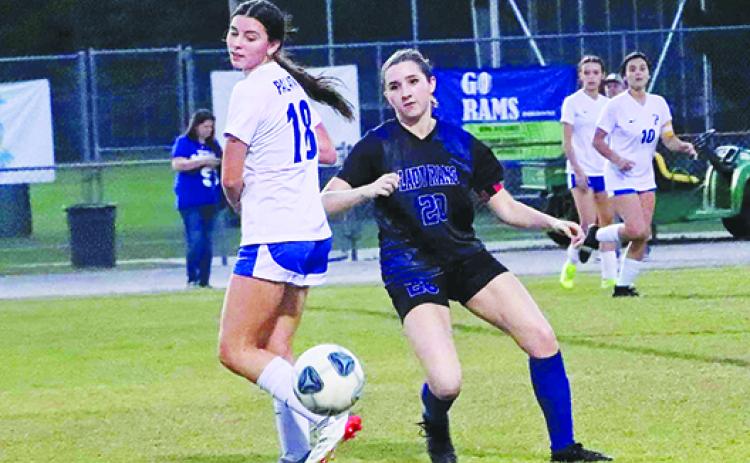 Interlachen’s Erin Jacobsen (20) goes after a ball behind Palatka’s Lanie Hutchinson during the first half of Friday’s match at Feltner Field at Thompson-Baker Stadium. (RITA FULLERTON / Special to the Daily News)