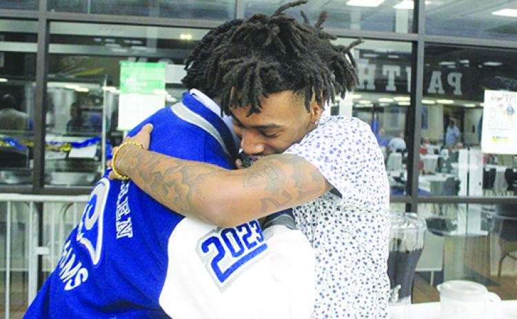 Three-time All-County standouts and close friends Reggie Allen Jr. (left) and Chavaris Dumas share a hug moments after Allen won the Jim McCool All-County Football Team player of the year honor on Dec. 12 at Palatka Junior-Senior High School. (MARK BLUMENTHAL / Palatka Daily News)