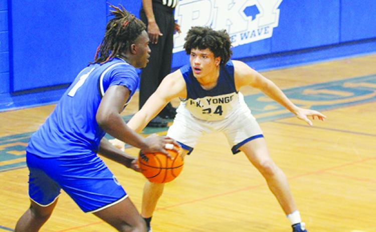 nterlachen’s Justin Herring looks to make a move against P.K. Yonge’s Moses Horne in the fourth quarter of Friday’s District 2-3A boys basketball final. (MARK BLUMENTHAL / Palatka Daily News)