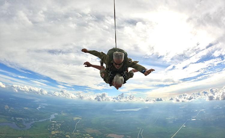 Courtesy of the Round Canopy Parachuting Team-USA. Vince Speranza, a 98-Year-old World War II Veteran Paratrooper of the 101st Airborne Division shortly after leaving a vintage World War II C-47 for a tandem skydive with Art Shaffer of Skydive Palatka.