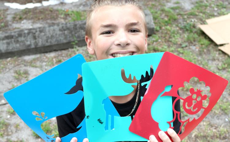 Braxton Malloy, 11, of Welaka shows some of the stencils he chose for his Street Art inspired by Banksy class on Wednesday during the Palatka Art League Kids Summer Art Program camp. (Photos by TRISHA MURPHY / Palatka Daily News)