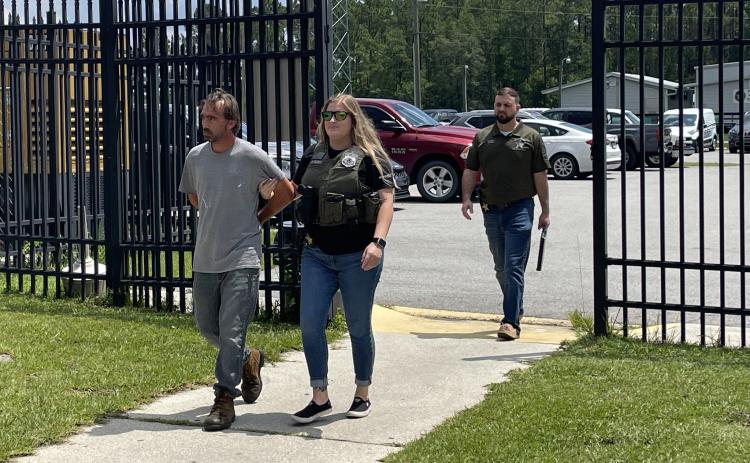 Courtesy of the Putnam County Sheriff's Office. Glenn Dykes is escorted to jail by Putnam County Sheriff's Office law enforcement officers on Friday.