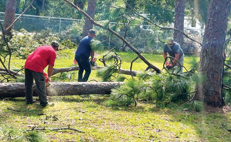 Photo courtesy of the Putnam County School District – Putnam County School District maintenance workers help remove fallen trees Friday as they help Dixie County recover from Hurricane Idalia.