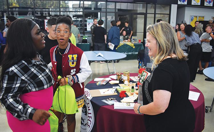 BRANDON D. OLIVER/Palatka Daily News – Christina McNiel, right, the director of admissions and student services for Dragon Rises College of Oriental Medicine, talks to local students about what the school offers during the Putnam County College & Career Fair on Tuesday.