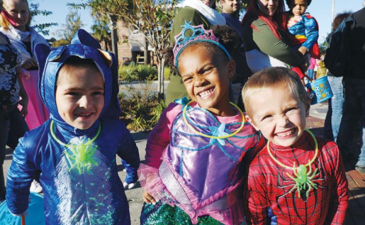 File photo – Costumed children and their families prepare to get candy during a Halloween event at the Palatka riverfront in 2021.