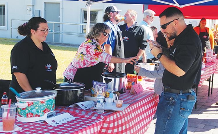 File photo – People serve and taste chili during a Ten-24 Foundatiion fundraiser in 2022. This year, the fundraiser will be a barbecue cookoff.