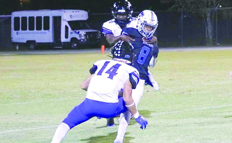Interlachen’s Dante Astin (8) is corraled down by Mount Dora Christian’s Xavier Dalton (behind) and Jourdan Betances during last Friday night’s game. (RITA FULLERTON / Special to the Daily News)