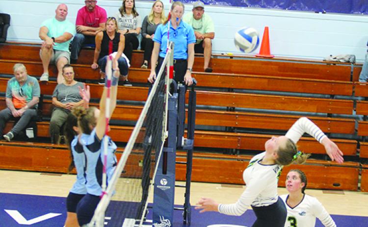 St. Johns River State College’s Brittany Cowart goes high for a kill attempt against two Santa Fe defenders during Tuesday’s match at Tuten Gymnasium. (MARK BLUMENTHAL / Palatka Daily News)