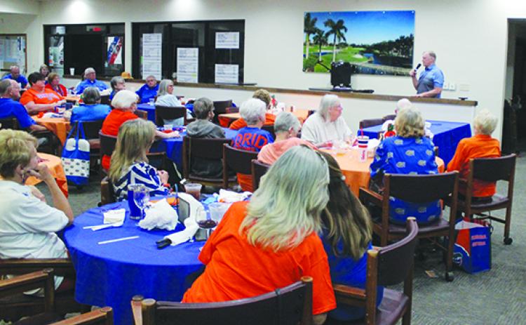 “The Blitz With Mark McLeod” host Mark McLeod (in background) addresses the crowd at Tuesday’s Gator Club meeting at the Palatka Municipal Golf Club. (MARK BLUMENTHAL / Palatka Daily News)
