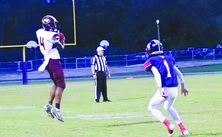 Crescent City’s Lentavious Keenon (4) catches a pass last Friday night in front of Pierson Taylor’s Alex Gomez. (RITA FULLERTON / Special to the Daily News)
