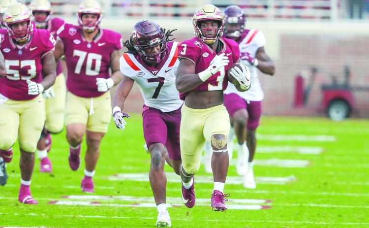 Florida State’s Trey Benson tries to outrace Virginia Tech’s Keonta Jenkins during Saturday’s game at Doak Campbell Stadium. (GREG OYSTER / Special to the Daily News)