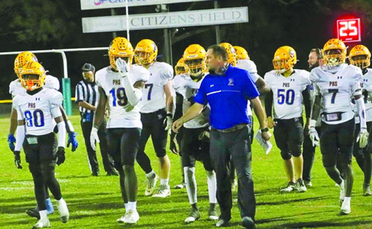 Palatka Junior-Senior High head football coach Patrick Turner (center) and his team go off the field at halftime of Friday’s 28-27 loss to Gainesville Eastside at Citizen’s Field. (RITA FULLERTON / Special t the Daily News)