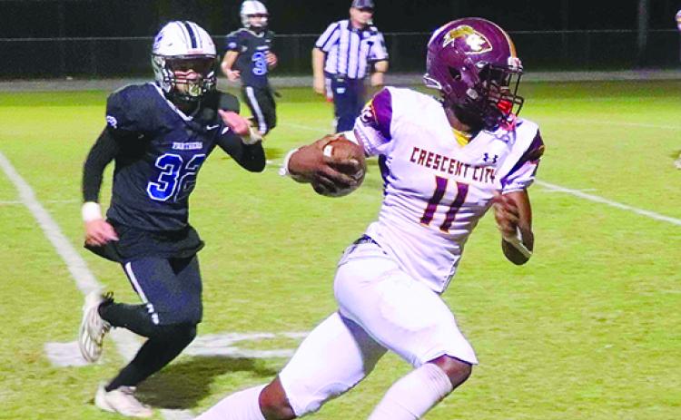 Crescent City’s Freddy Major dashes toward the end zone in the first half of Friday night’s game while being pursued by Orange Park Ridgeview’s Chuckie Mendat. (RITA FULLERTON / Special to the Daily News)