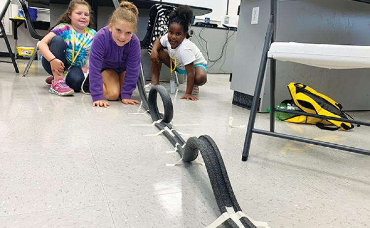 File photo – Putnam County School District students test out the mini rollercoaster they built during a STEM camp in 2022.