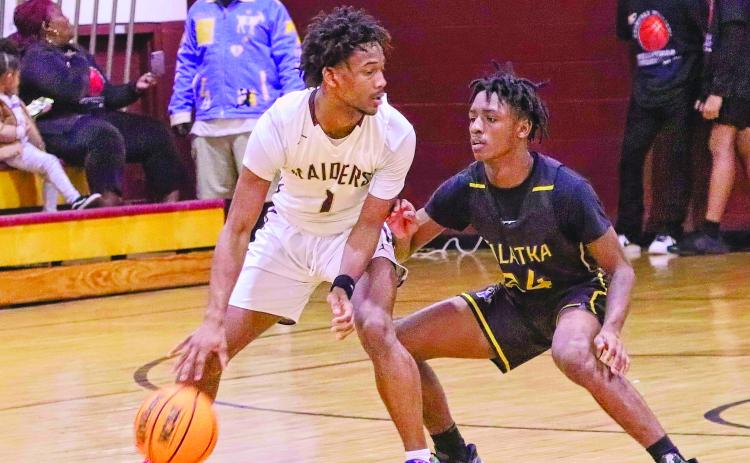  Crescent City’s Lentavius Keenon (1) is guarded closely by Palatka’s Tommy Offord during Friday night’s game in the Clarence “Pooh Bear” Williams Classic tournament at Crescent City. (RITA FULLERTON / Special to the Daily News)