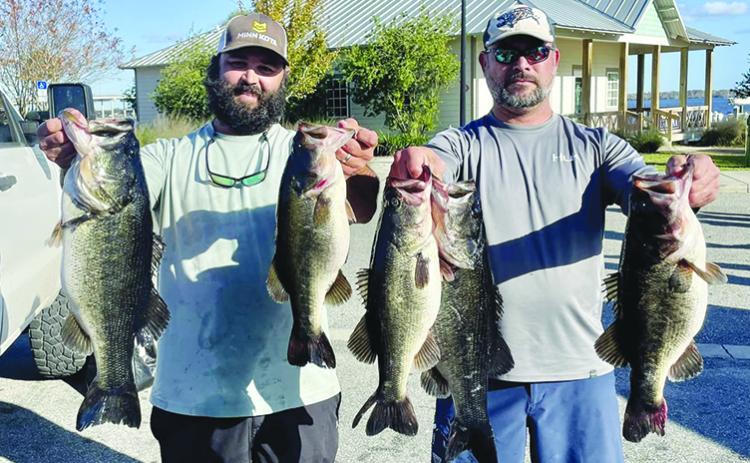 Buck and Michael Albritton hold up their winning fish from the pre-Christmas tournament held this past Saturday. (GREG WALKER / Daily News correspondent)