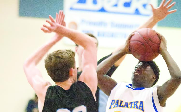 Palatka’s Anfernee Royster puts a shot up against Ponte Vedra’s Ross McCarthy during the first half of Palatka’s 62-51 district regular-season victory on Jan. 10, 2015, at Palatka. (Daily News file photo)