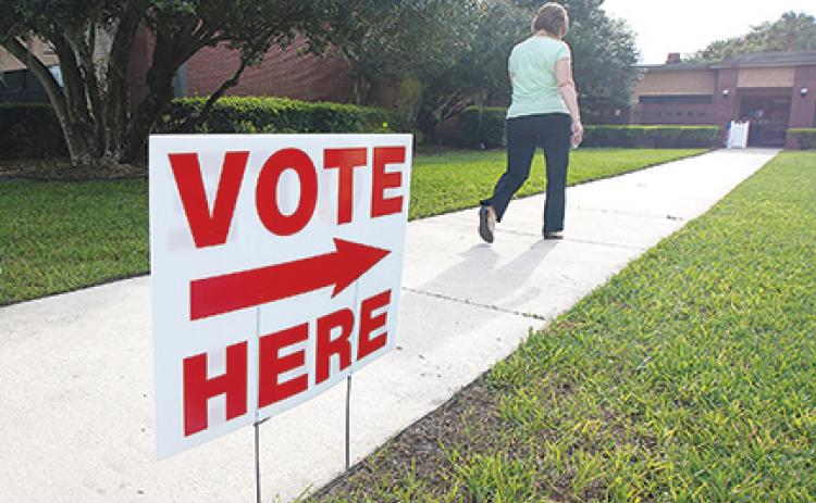 File photo – A woman walks into her polling place at St. Johns River State College