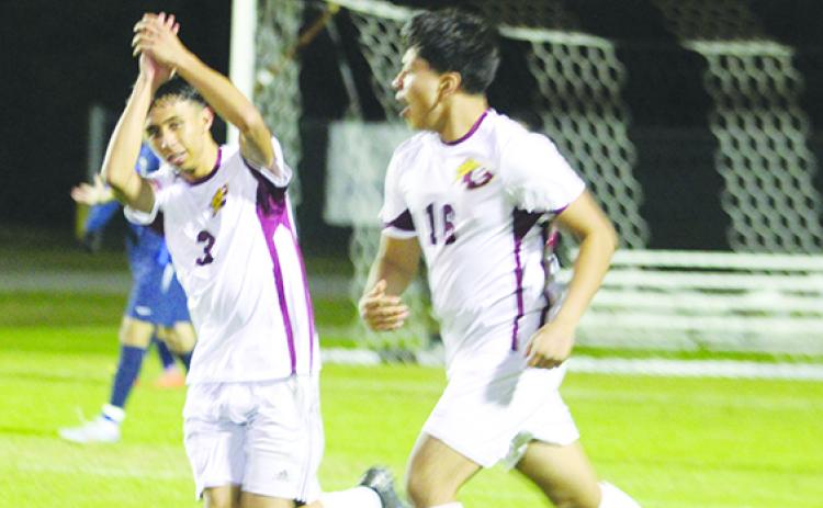 Crescent City's Adrian Pena celebrates scoring a goal in the second half of Thursday night's 1-1 tie with Pierson Taylor. Next to Pena is teammate Bryan Garcia. (MARK BLUMENTHAL / Palatka Daily News)