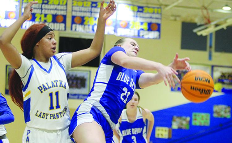 Clay High School’s Julia Weaver (21) battles for a rebound with Palatka’s Charnelle Cue during Wednesday night’s girls basketball game. (MARK BLUMENTHAL / Palatka Daily News)