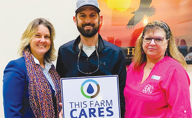 Submitted by Jackie Fazzolari – Wendy Mussoline, left, and Jackie Fazzolari, right, celebrate Jon William Revels, center, for being recognized by the Putnam County Board of Commissioners for receiving the Florida Farm Bureau’s This Farm Cares Award.