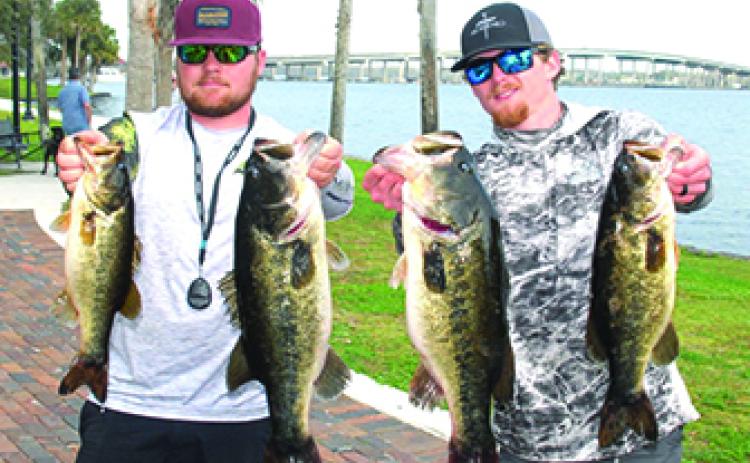 Wyatt Kinney (left) and Austin Black hold up there winning fish at the Palatka Docks on Feb. 10. (GREG WALKER / Daily News correspondent)