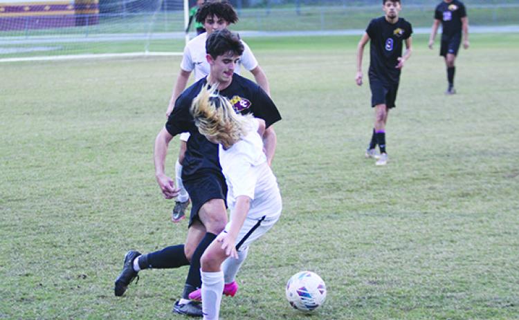 David Newbold (in black uniform) works the ball up the field for Crescent City during its District 9-3A first-round match with Daytona Beach Father Lopez. The Raiders' season came to an end Tuesday in the Region 3-3A tournament in a 4-0 loss at North Palm Beach Benjamin School. (MARK BLUMENTHAL / Palatka Daily News)