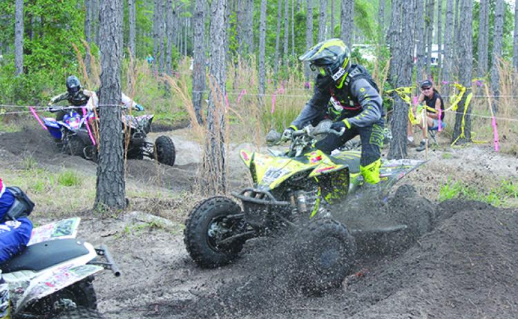 Racers run their ATVs through the dirt during last March’s racing at Hog Waller. (MARK BLUMENTHAL / Palatka Daily News)