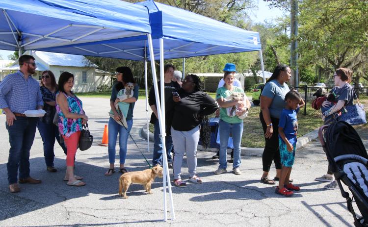 SARAH CAVACINI/Palatka Daily News. New pet owners wait for their dogs to receive their vaccinations on March 15 at the Putnam County Governmental Complex. 