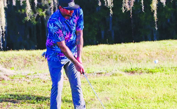 Shawn Hatfield of Palatka takes a swing on the seventh hole during Friday’s first round at the Azalea Amateur Golf Championship. Below, Jeffrey Whiplle of Jacksonville putts on the eighth green. Hatfield finished with a 95, while Whipple shot a 94. (RITA FULLERTON / Special to the Daily News)