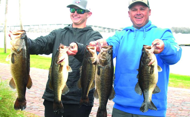 Parker and Lee Stalvey hold up their winning fish in the recent Andy’s Bass Trails qualifier. (GREG WALKER / Daily News correspondent)