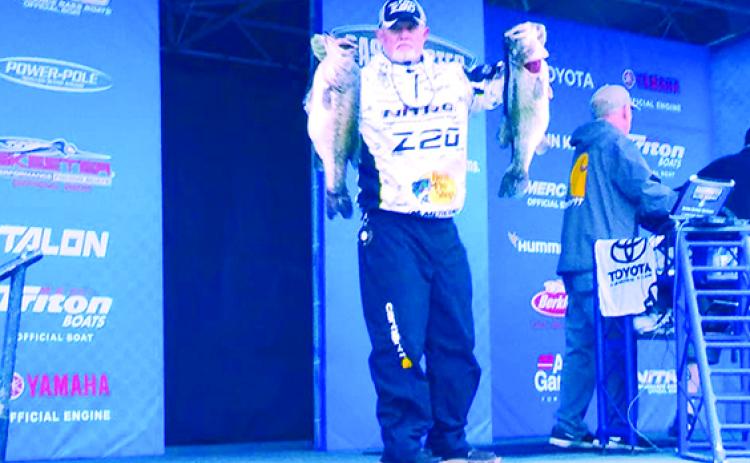 Rick Clunn shows off two of his five-fish catch of 34 pounds, 10 ounces on the final day of the Bassmaster Elite at St. Johns River to come from eighth place and win the title on Feb. 10, 2019. (MARK BLUMENTHAL / Palatka Daily News)