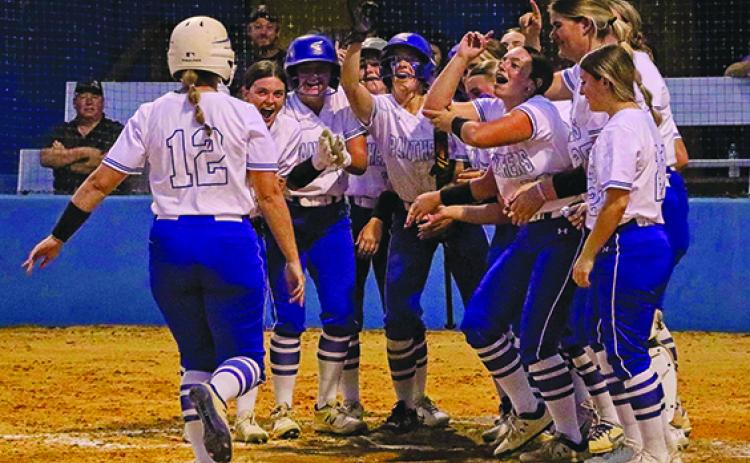 Palatka’s Haleigh Faulkner is greeted at home plate by happy teammates after hitting a three-run, first-inning home run Monday against Interlachen. (RITA FULLERTON / Special to the Daily News)