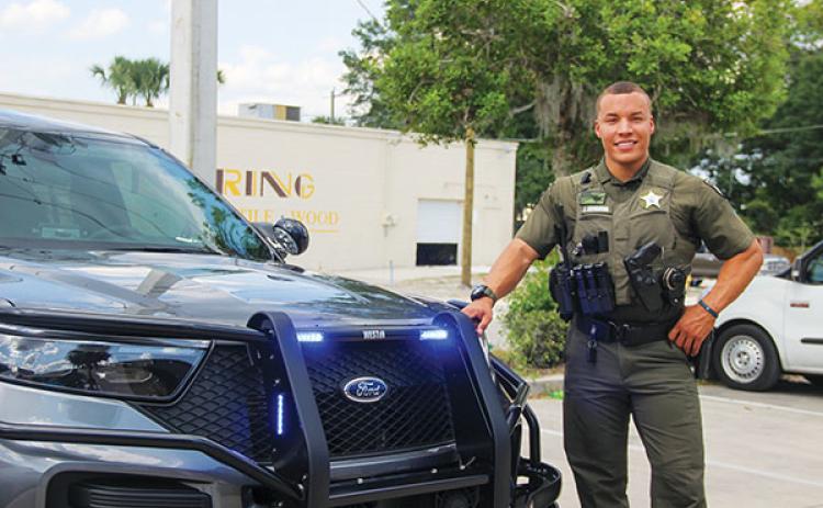 SARAH CAVACINI/Palatka Daily News – Putnam County Sheriff’s Office Deputy Alex Drummond stands next to his patrol vehicle Tuesday ahead of the “Police 24/7” premiere.