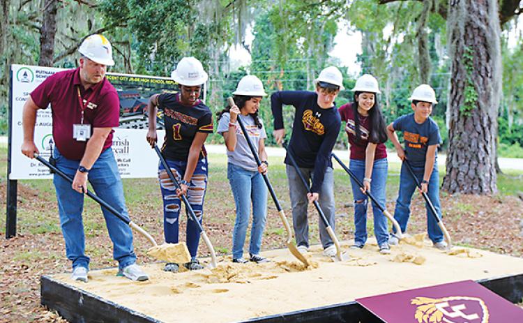 SARAH CAVACINI/Palatka Daily News – Principal Tim Adams, left, and some of his students break ground Friday at the site of the new Crescent City Junior-Senior High School. 