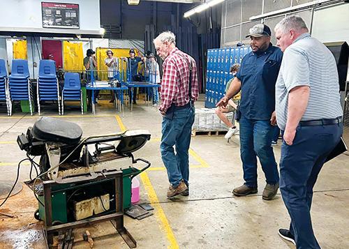 Photo courtesy of the Putnam County School District – Airgas representatives Scott Carter and Jim Homan talk with Palatka Junior Senior-High School welding instructor Levi Bennet during a visit to the Palatka facility Wednesday.