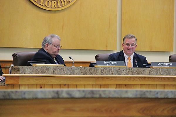 SARAH CAVACINI/Palatka Daily News – County Commissioner Terry Turner, left, listens while Commissioner Larry Harvey gives his input on county business during a Board of County Commissioners meeting Tuesday.