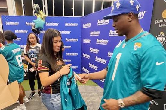 Crescent City’s Paola Cruz has her Jacksonville Jaguars jersey signed by Jaguars running back Travis Etienne last week. (Submitted / Keenan Henry)