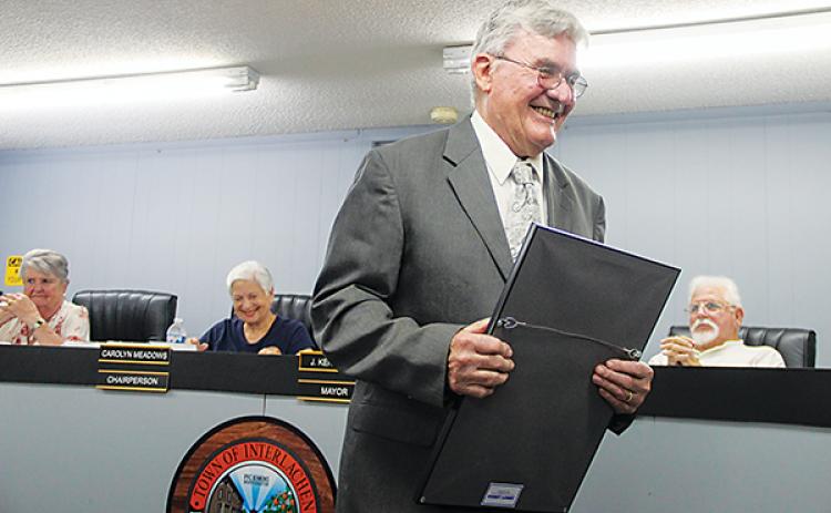 SARAH CAVACINI/Palatka Daily News – Interlachen Mayor Ken Larsen walks back to his seat on the Town Council on Tuesday after receiving an award to honor his 20 years of service as an elected town official.
