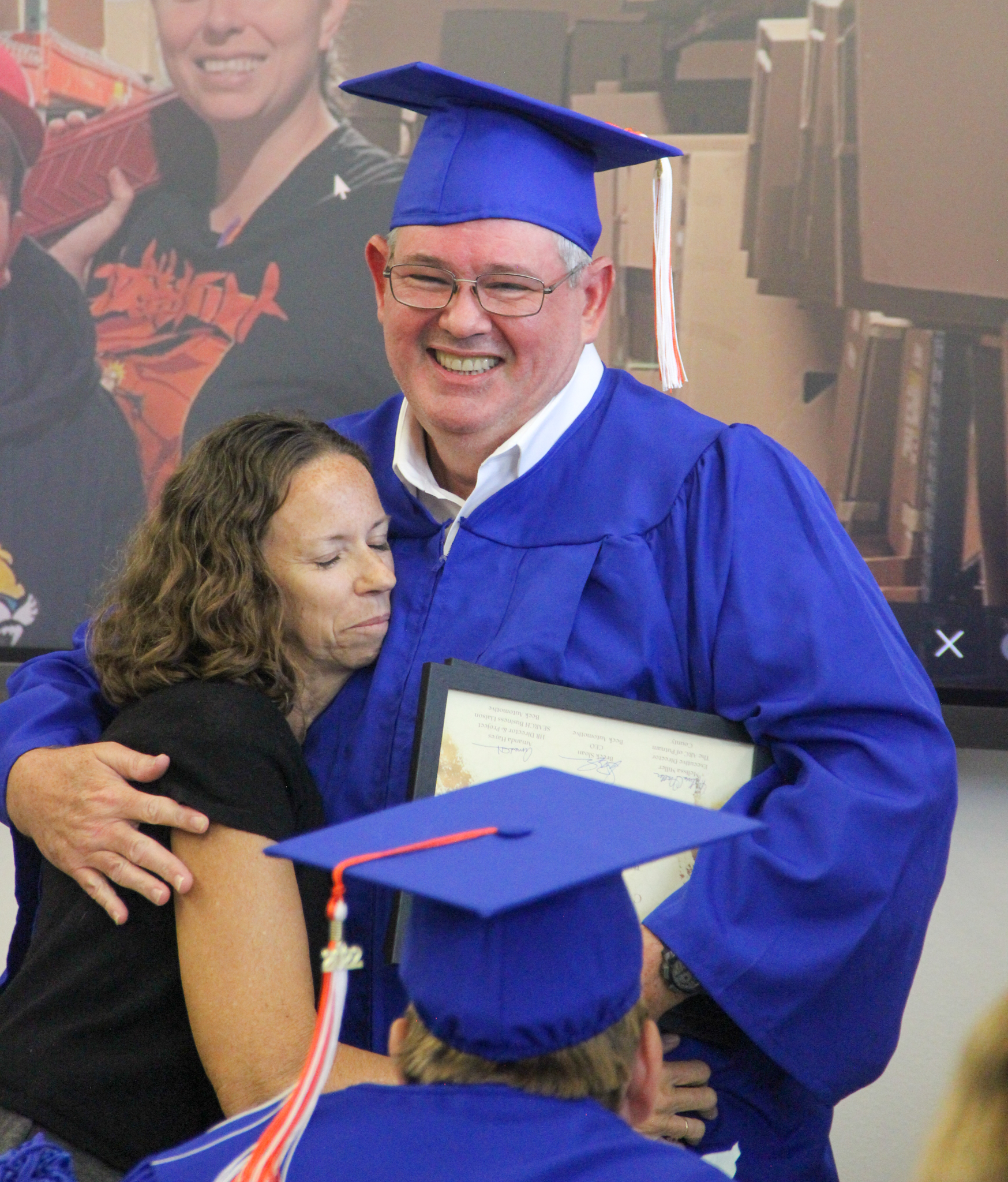 Project SEARCH graduate Bradley Waldrop is all smiles as he hugs Arc skills trainer Patty Dame during a graduation ceremony Friday. 